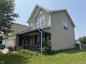 Inviting two-story home with a covered porch, stone accents, and attractive landscaping at 9704 Gull Lake Dr, Indianapolis, IN 46239
