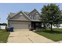 Attractive two-story house showcasing a well-maintained lawn, covered porch, and neutral siding at 9704 Gull Lake Dr, Indianapolis, IN 46239