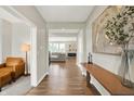 Inviting foyer with wood flooring, modern artwork, and flowing transition into the adjacent living spaces at 9716 Cimmaron Ave, McCordsville, IN 46055