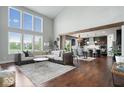 Bright, open-concept living space with large windows, soaring ceilings, and hardwood floors at 10054 Win Star Way, Fishers, IN 46040
