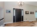 Inviting foyer with wood-look floors and decorative front door with sidelights at 102 Roxbury Ln, Noblesville, IN 46062