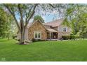 Two-story home featuring stone accents and a well-maintained lawn at 102 Roxbury Ln, Noblesville, IN 46062