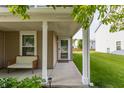 Inviting front porch with seating, neutral columns, and a view of the landscaped lawn at 10273 Haag Rd, Brownsburg, IN 46112