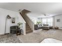 Spacious living room with neutral walls, carpeted stairs, and cozy seating at 10273 Haag Rd, Brownsburg, IN 46112