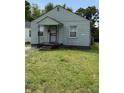 A compact single-story house with a small front yard needing some TLC at 1030 N Concord N St, Indianapolis, IN 46222