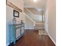 Inviting foyer with hardwood floors, staircase, and stylish decor at 10760 Independence Way, Carmel, IN 46032