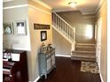 Welcoming foyer showcasing hardwood floors, a staircase, and decorative accents at 10760 Independence Way, Carmel, IN 46032