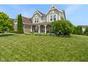 Charming two-story home boasting manicured lawn and lush landscape at 1102 Clearwell Dr, Greenwood, IN 46143