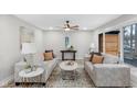 Bright living room with neutral walls and trim, stylish decor, recessed lighting, and ceiling fan at 11035 W Lakeshore Dr, Carmel, IN 46033