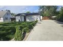 Home with green lawn and concrete driveway at 1125 S Drexel Ave, Indianapolis, IN 46203