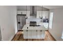 Open kitchen featuring a stylish island, stainless steel appliances, and modern backsplash at 1125 S Drexel Ave, Indianapolis, IN 46203
