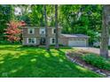 Charming two-story home with attached two-car garage and a lush green front yard at 11510 Ralston Ave, Carmel, IN 46032