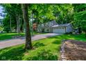 Two-story home with attached two-car garage and a driveway, surrounded by mature trees and a green lawn at 11510 Ralston Ave, Carmel, IN 46032