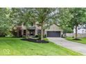 Inviting two-story home with brick accents, a two-car garage, and beautifully landscaped front yard at 11987 Quarry Ct, Fishers, IN 46037
