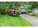Charming two-story home featuring mature trees, a well-kept lawn, and a convenient two-car garage at 11987 Quarry Ct, Fishers, IN 46037