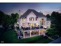 Expansive two-level outdoor living space with covered seating, dining, and entertainment areas at 12192 Woods Bay Pl, Carmel, IN 46033