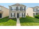 Charming two-story home featuring a well-maintained lawn and classic black shutters at 12671 Endurance Dr, Fishers, IN 46037