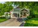 Inviting craftsman home with manicured landscaping, a beautiful lawn, and American flag at 140 4Th Nw St, Carmel, IN 46032