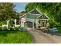 Inviting craftsman home with manicured landscaping, a beautiful lawn, and American flag at 140 4Th Nw St, Carmel, IN 46032