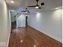 Bright living room with hardwood floors, white walls, recessed lighting, and staircase access at 1421 S Meridian St, Indianapolis, IN 46225