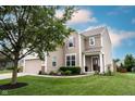 Beautiful home with an attached garage, lush green lawn, and inviting front entrance at 14514 Glapthorn Rd, Fishers, IN 46037