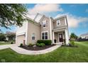 Attractive two-story home featuring manicured landscaping, inviting curb appeal, and a cozy entrance at 14514 Glapthorn Rd, Fishers, IN 46037