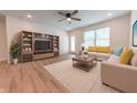 Bright living room with a ceiling fan, and a view of the backyard at 1452 Coen Ct, Columbus, IN 47201