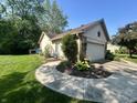 Charming home exterior featuring stone accents, tidy landscaping, and an attached two-car garage at 177 Wellington Pkwy, Noblesville, IN 46060
