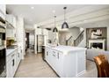 Open concept kitchen features an island, stainless steel appliances, and connects to the living room at 18956 Seaforth Way, Westfield, IN 46074