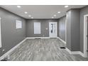 Spacious living room with modern gray walls, wood-look floors, and recessed lighting at 2035 S Pennsylvania St, Indianapolis, IN 46225