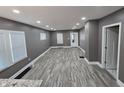 Bright living room featuring recessed lights, gray walls, and wood-look floors at 2035 S Pennsylvania St, Indianapolis, IN 46225