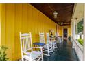 Inviting covered porch featuring classic white rocking chairs, offering a relaxing outdoor space at 224 N Pennsylvania St, Greenfield, IN 46140