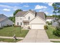 Charming two-story home featuring a combination of brick and vinyl siding with an attached two car garage at 2326 Gradison Cir, Indianapolis, IN 46214