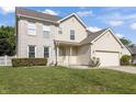 Attractive two-story home with a well-manicured lawn, brick accents, and a welcoming front porch at 2326 Gradison Cir, Indianapolis, IN 46214