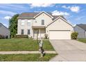 Charming two-story home featuring a combination of brick and vinyl siding with an attached two car garage at 2326 Gradison Cir, Indianapolis, IN 46214
