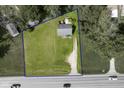 Aerial view of a lot with a blue border, home, shed and driveway along a street with passing cars at 2710 W State Road 38, Sheridan, IN 46069