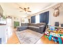 Open-concept living room with hardwood floors, a large sectional sofa, and natural light at 272 Jefferson St, Columbus, IN 47201