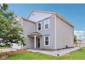 The side view of this two-story home shows the well maintained lawn and neat gray siding at 2887 Ludwig Dr, Indianapolis, IN 46239