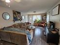 Inviting living room features a large sectional sofa, hardwood floors, and natural light, creating a warm and cozy atmosphere at 29 Home Ave, Markleville, IN 46056