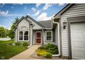 Inviting exterior view of well-maintained home and lush landscaping with a red front door at 2905 Inverrary Ct, Indianapolis, IN 46234