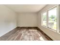 Sunny bedroom with wood-look floors and ample natural light through large windows at 3242 Welch Dr, Indianapolis, IN 46224