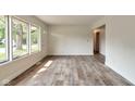 Bright and airy living room with large windows and durable wood-look flooring at 3242 Welch Dr, Indianapolis, IN 46224