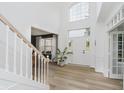 Bright foyer with soaring ceilings, white walls, wood floors, staircase and lots of natural light at 3876 Kegler Way, Carmel, IN 46074