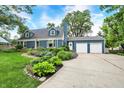 Landscaped front yard and a two-car garage enhance this home's curb appeal at 3940 E 57Th St, Indianapolis, IN 46220