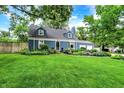Well-maintained lawn and landscaping complement this cozy home at 3940 E 57Th St, Indianapolis, IN 46220