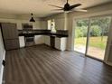 Bright eat-in kitchen with stainless appliances, white cabinets, and sliding glass doors to backyard at 4343 W Fairview Rd, Greenwood, IN 46142