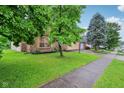 A view of the front exterior and lawn of the home from the street sidewalk at 4933 Common Vista Way, Indianapolis, IN 46220