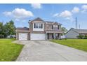 Charming two-story brick home with a three-car garage and well-manicured lawn at 5030 E 800 N, Columbus, IN 47203