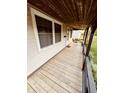 View of the covered porch offering a seating area, wooden decking, and an inviting entrance to the home at 514 W 6Th St, Sheridan, IN 46069