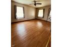 Spacious living room with hardwood flooring, neutral walls, and two windows providing ample natural light at 514 W 6Th St, Sheridan, IN 46069